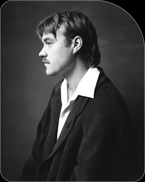 Black and white side-profile portrait of Aistis