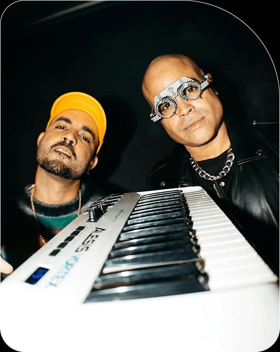 Coastcity duo posing behind a keyboard